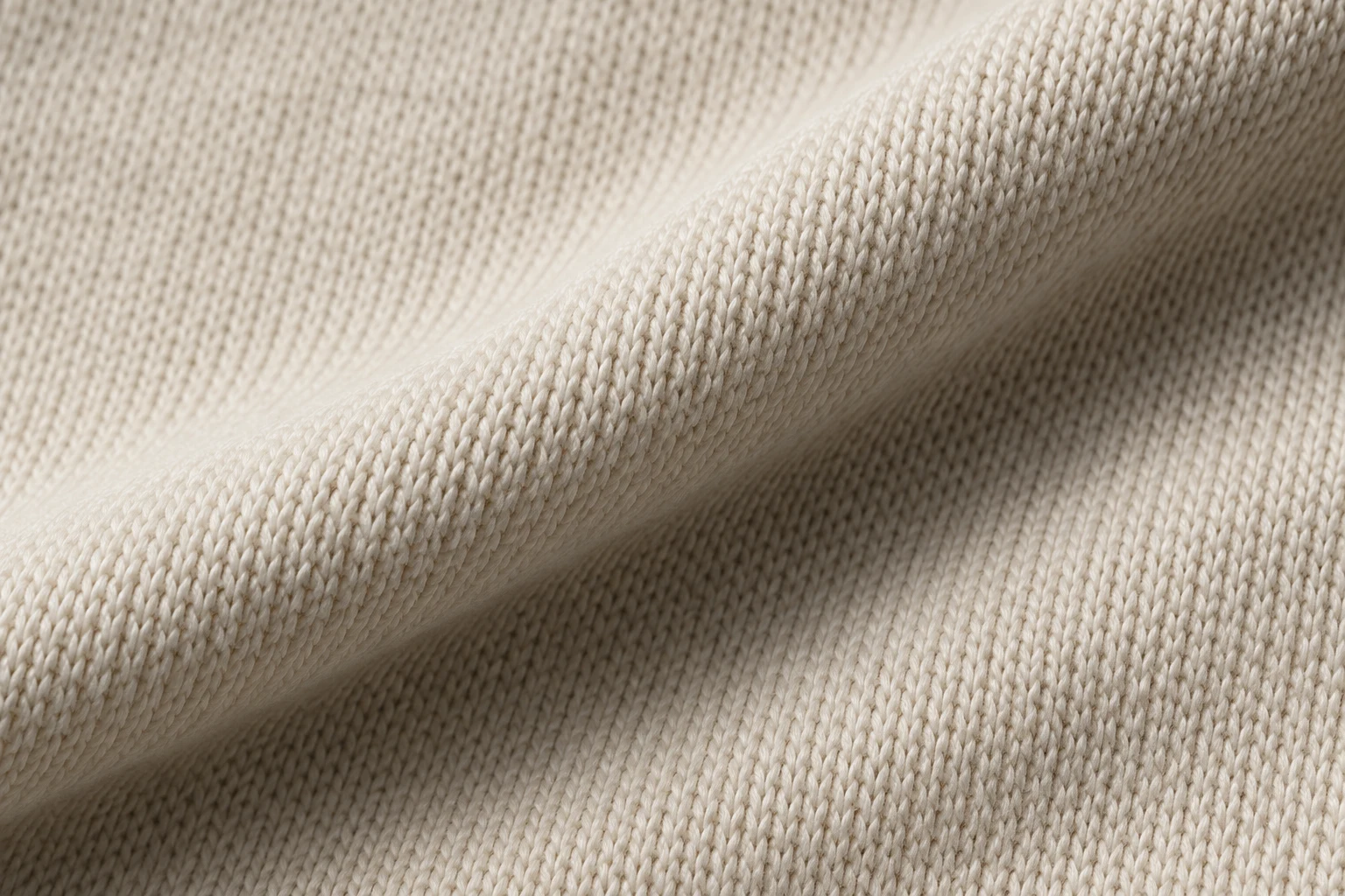 Concept macro photograph of ivory cotton jersey knit and a fold